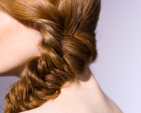 Close-up of woman with braid in hair